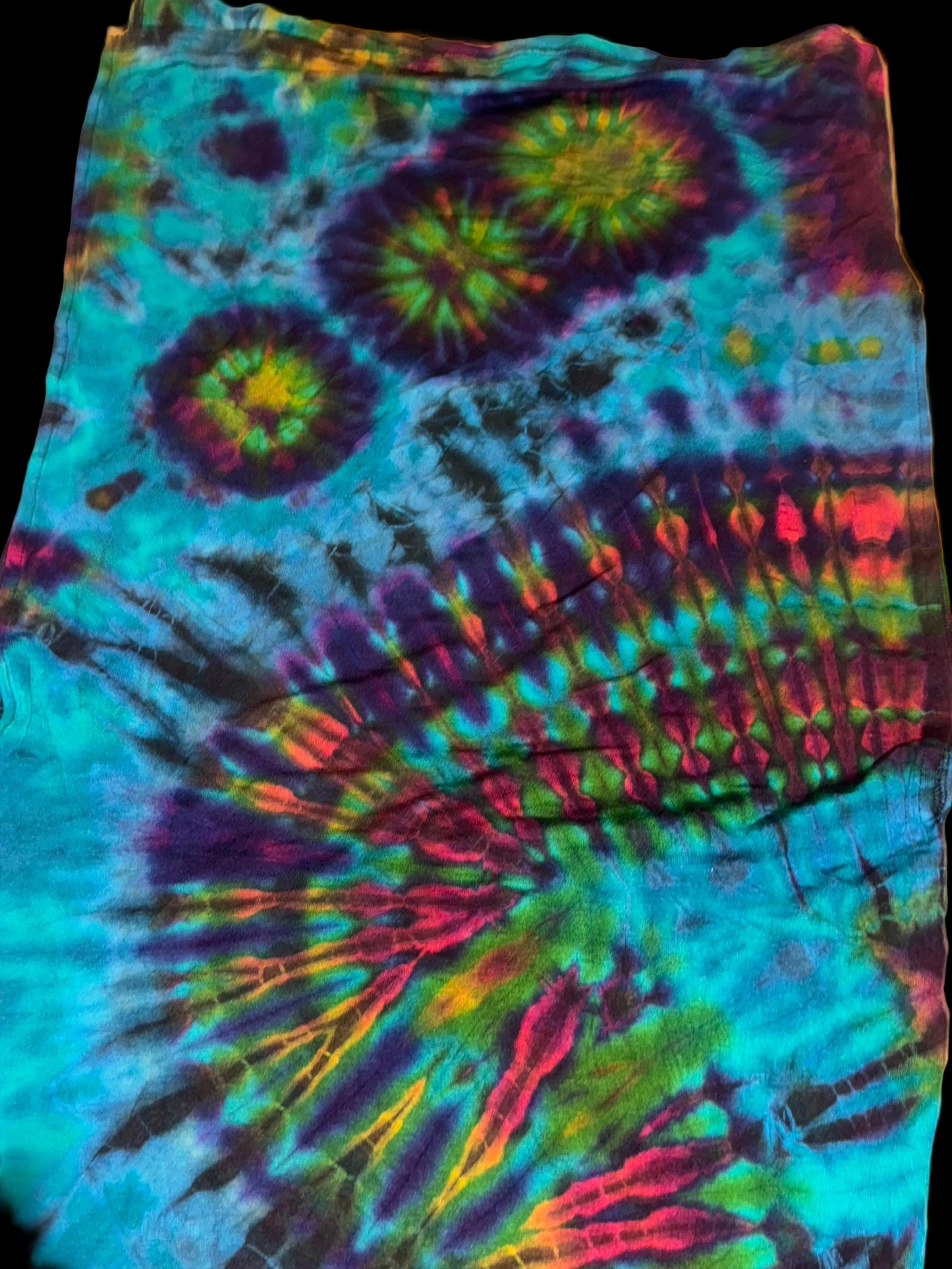 Tie-dye fabric with multicolor pattern on a white background