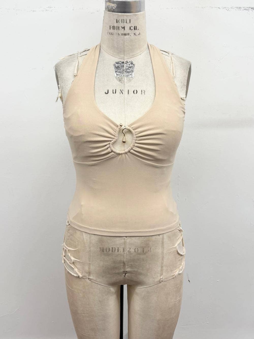 Beige tank top and shorts set on a mannequin against a white background