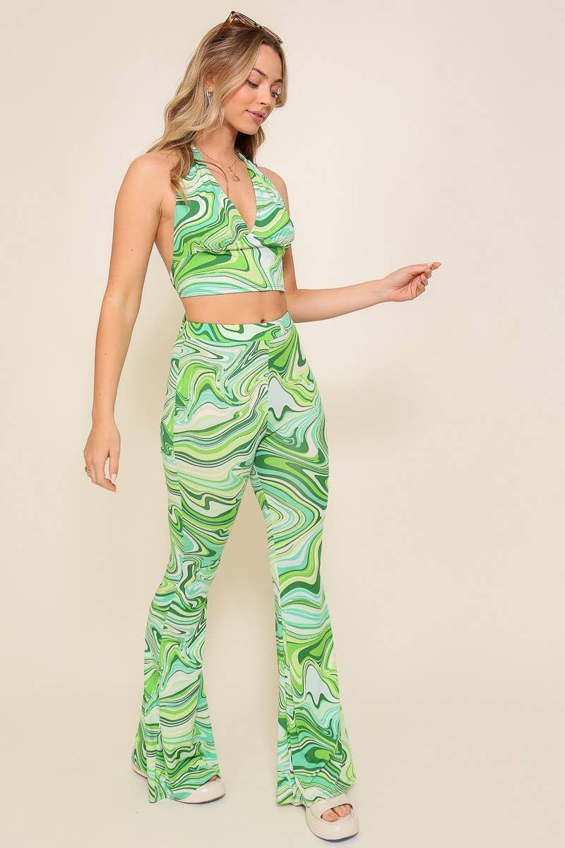 Woman wearing a green and white patterned outfit on a beige background