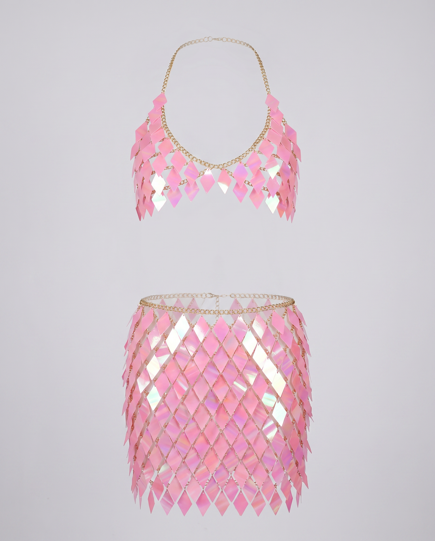 Pink iridescent chain crop top and skirt set with diamond-shaped panels for festival wear