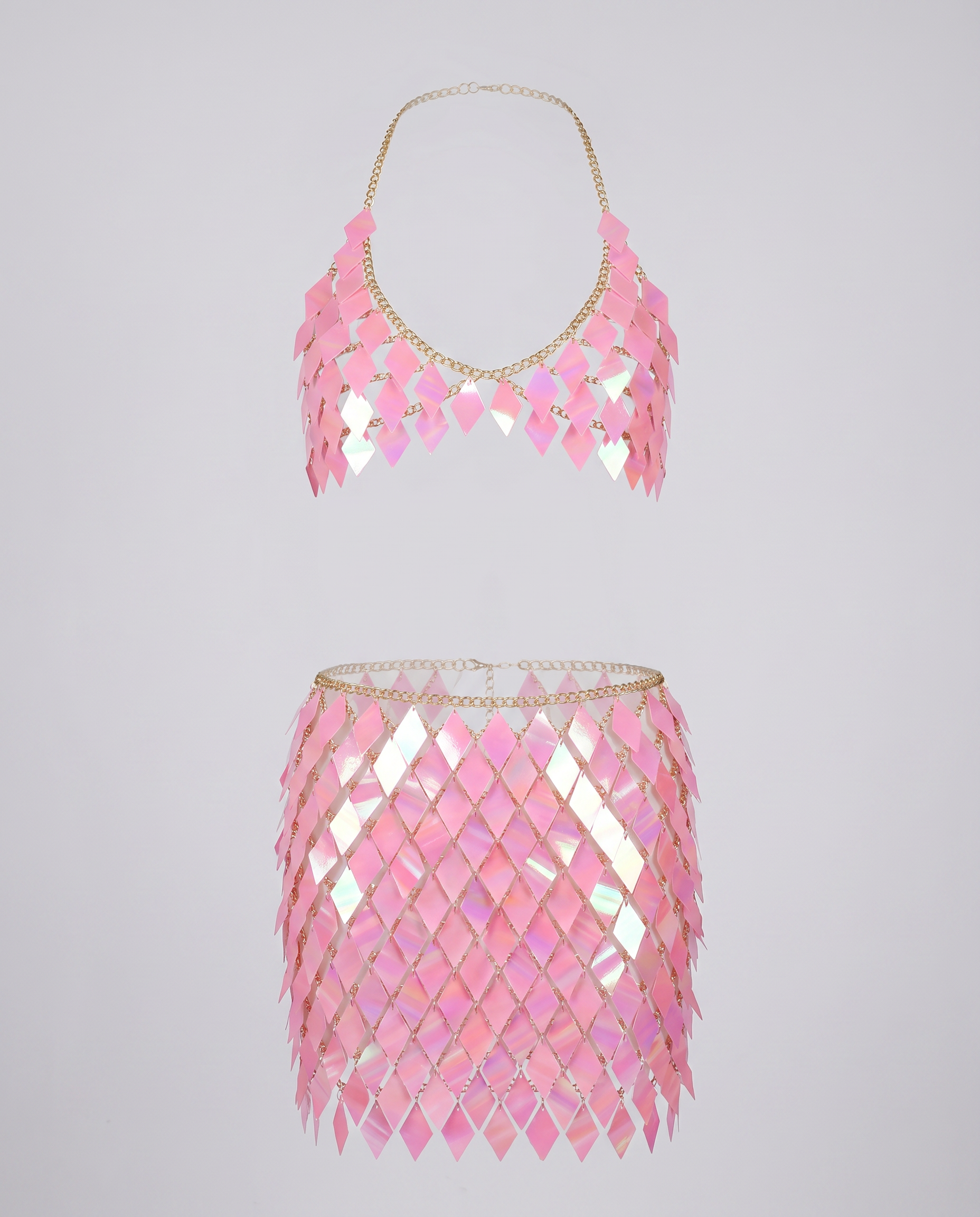 Pink iridescent chain crop top and skirt set with diamond-shaped panels for festival wear