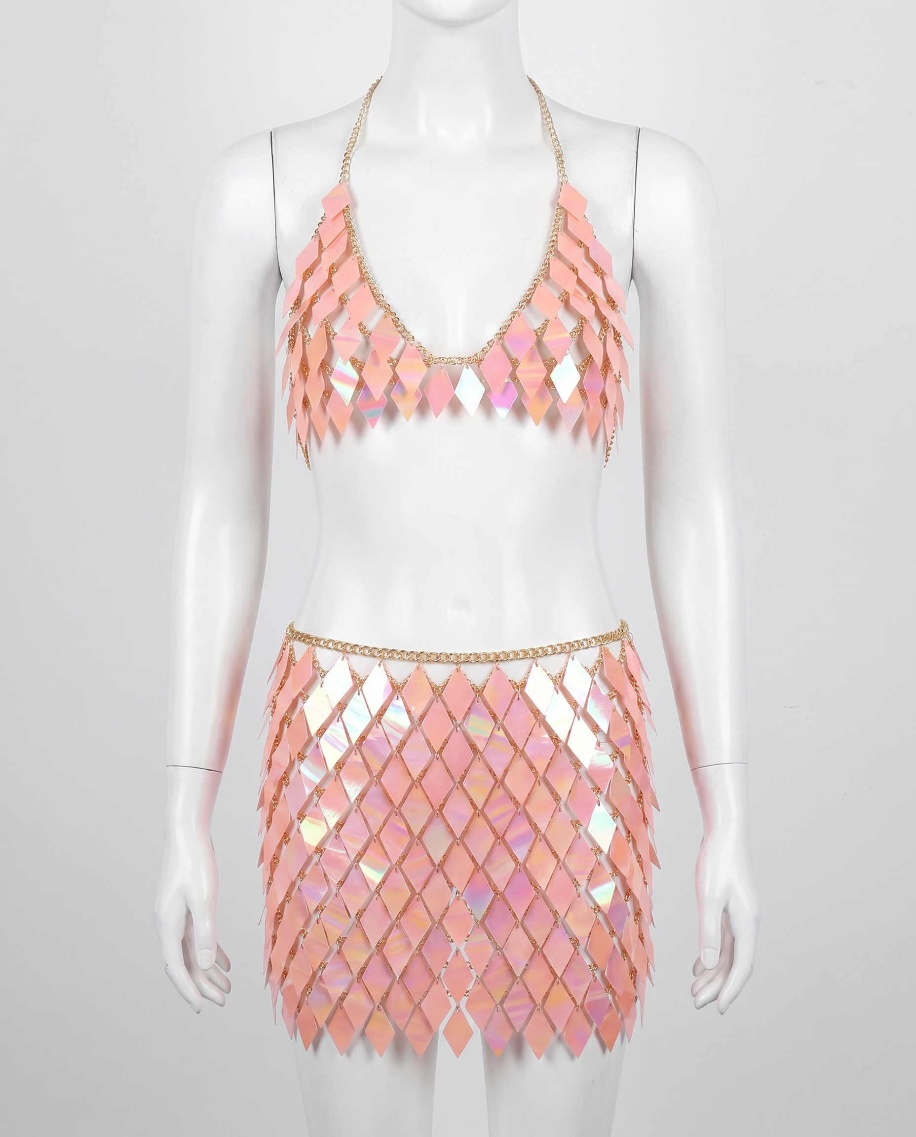 Iridescent pink festival outfit with diamond-shaped sequin top and matching skirt on mannequin
