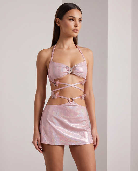 Woman in iridescent pink festival outfit with butterfly accents and strappy crop top