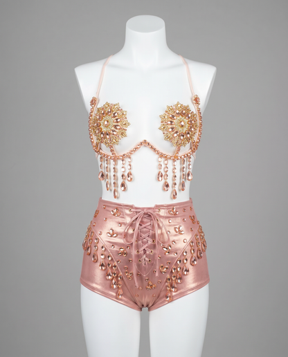 Mannequin wearing embellished pink festival bra top and high-waisted shorts with gems