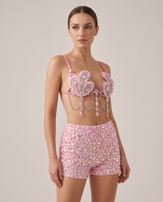 Model in pink iridescent festival bra top with crystal embellishments and matching shorts