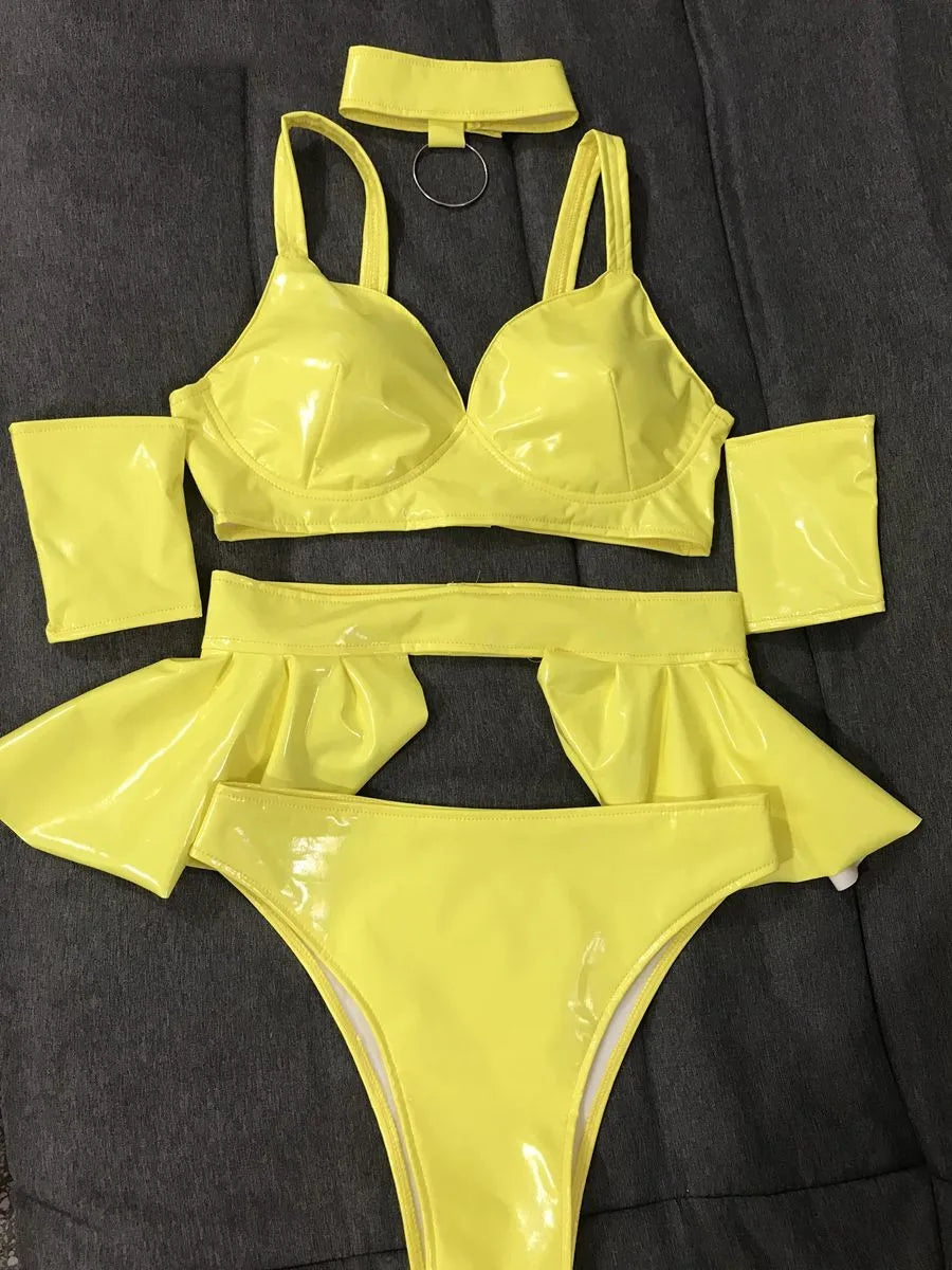 High-visibilityyellow festival two-piece with body-contouring technology and UV-reactive aesthetic for main stage sets.