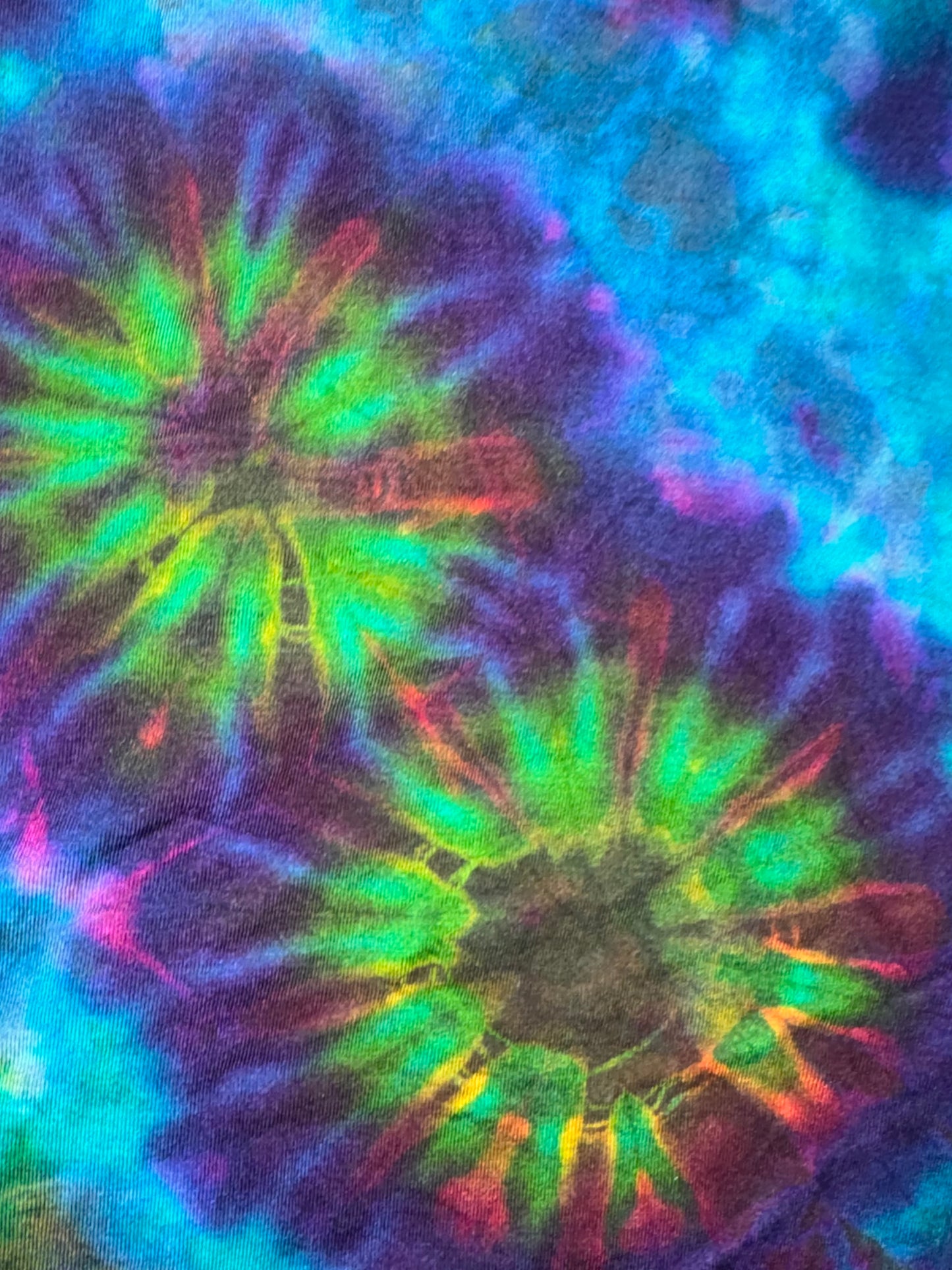 Tie-dye pattern with vibrant colors on a fabric background