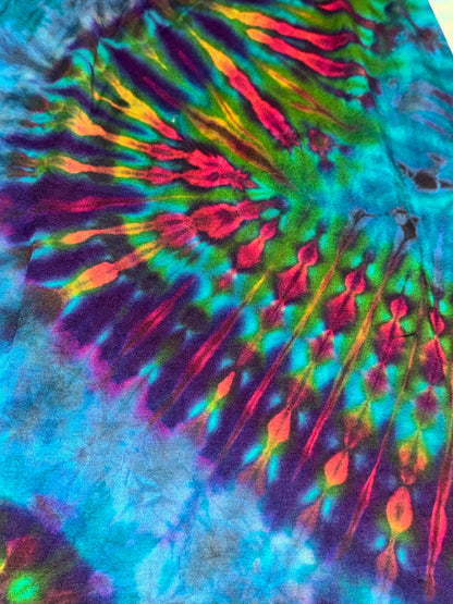 Close-up of a tie-dye pattern with vibrant colors on a fabric background